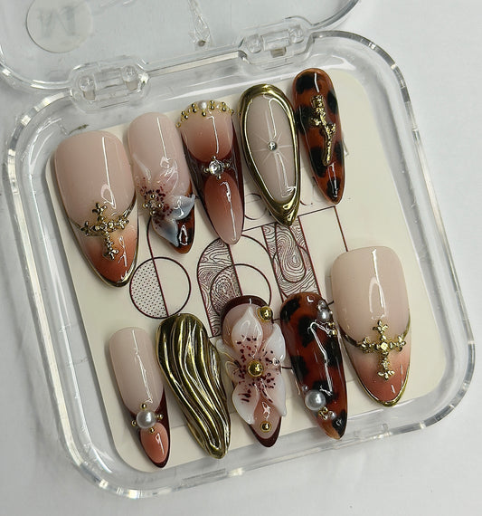 Set of decorative false nails in a clear case on a white background